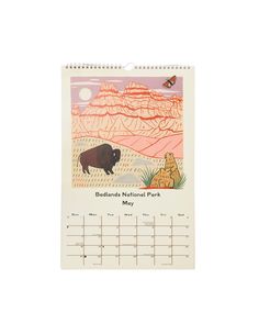 a desk calendar with an image of a buffalo and a bear on the cover, which reads beautiful national park may