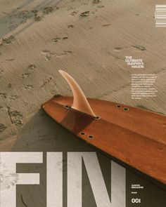 a surfboard laying on the sand with its fin sticking out from it's side