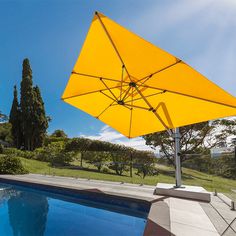 an umbrella over a swimming pool on a sunny day