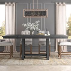 a dining room table with chairs and a chandelier