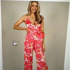 Chic Jumpsuit With Side Tie Detail In Floral Pink And White Tones. Adjustable Straps, Flared Leg, Invisible Back Zip Closure, Lined. 97% Polyester, 3% Spandex. Hand Wash. Flirty Pink Jumpsuits And Rompers For Vacation, Flirty Pink Jumpsuits And Rompers For Beach, Fitted Printed Jumpsuits And Rompers For Day Out, Chic Red Jumpsuits And Rompers For Vacation, Flirty Red Jumpsuits And Rompers For Summer, Flirty Sleeveless Floral Print Jumpsuits And Rompers, Floral Print Sleeveless Flirty Jumpsuit, White Floral Print Jumpsuits And Rompers For Party, Red One-piece Jumpsuit For Spring