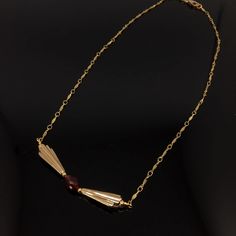 "Do you love the Art Deco design period? Do you love Garnet? Do you love wearing unique one-of-a-kind artisan jewelry? If you answered yes to these questions then this amazing necklace deserves to be yours! Lightly curved, flat, Gold Fill links are linked together in an amazing chain. From the chain are Art Deco inspired light Bronze charms in a quintessential Art Deco fan design. They are a light Bronze but look like vintage gold. In the center of the Bronze charms i a gorgeous, clear, faceted, Antique Garnet Pendant Necklace, Vintage Red Gemstone Necklace, Vintage Ruby Gemstone Necklaces, Art Deco Gemstone Necklace For Anniversary, Garnet Birthstone Necklaces For Jewelry Making, Gold Garnet Necklace For Wedding, Garnet Birthstone Necklace For Jewelry Making, Vintage Birthstone Necklace For Anniversary, Art Deco Ruby Jewelry As A Gift