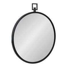 a round mirror hanging on the wall with a black frame and metal ring around it