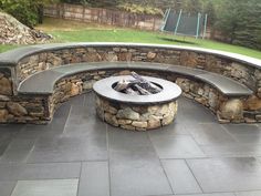 a fire pit sitting on top of a stone patio