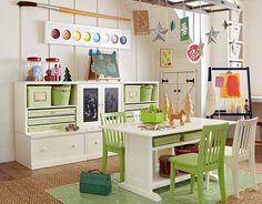 a white table and green chairs in a room