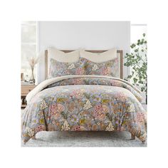 an image of a bed with floral comforter set