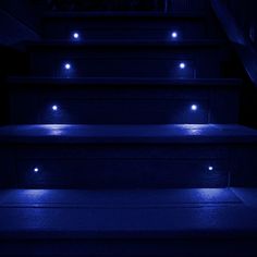 stairs lit up with blue lights in the dark