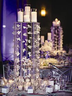 the centerpieces are filled with candles, flowers and crystal beads for an elegant touch