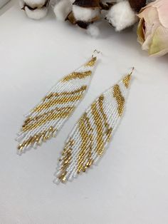 "Boho seed bead earrings, bridal metal beaded earrings, fringe white and gold seed bead earrings Length 5\" including ear wire Width 1\" Made with best quality Japanese seed beads, nickel finished seed beads, and 24k gold dipped seed beads Lightweight and unique extravagant style - designed and made by Luba Ro Colors used - glossy white, shimmering gold and gold Select closure earwires leverbacks clip-ons for non pierced ears" Gold Tassel Dangle Earrings With Tiny Beads, Gold Tassel Earrings With Tiny Beads, Elegant White Beaded Chain Earrings, White Beaded Chain Drop Earrings, Gold Tassel Earrings With Beaded Fringe, Gold Beaded Fringe Dangle Earrings, Bohemian White Beaded Earrings With Chain, Bohemian White Beaded Chain Earrings, White Earrings With Gold Round Beads