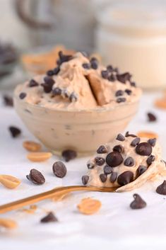 a bowl filled with ice cream and chocolate chips on top of a white tablecloth