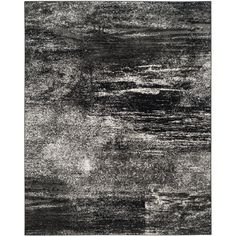 an abstract black and white rug with dark gray paint streaks on it, in the middle of