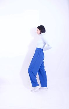 "AMAZING 90s vintage KORET sapphire blue elastic waist trouser  + excellent vintage condition + elastic back waist band  + cutest front pleat style  + high waist fit  + hand pockets  + super soft feel  + unique sapphire color + xt comfortable flowy wide leg free form fit  brand: koret  size: tag m  best fits: 27\"-34\" waist  measurements: (item lying flat, seam to seam)  waist: 13.5X2 pulls to 17\" hips across: 21.5\"  rise: 15\" inseam: 29.5\" material: 100% polyester  condition: excellent vintage condition, stain, tear, rip free  note: flash may increase color hues and vibrancy of item's material photoed on a medium frame: 5'8, 27\" waist  questions about item?  message additional questions and read shop FAQ's prior to purchase. please compare measurements, no returns or exchanges for i 90s Clothing, Minimalist Vintage, Flat Seam, Sapphire Color, Utility Pants, Sapphire Blue, Trouser Pants, 90s Vintage, Trousers Women