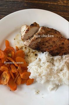 a white plate topped with meat, rice and carrots