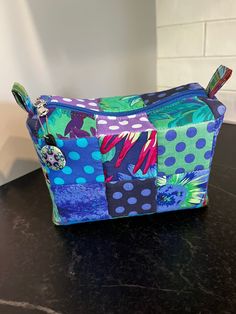 a colorful patchwork bag sitting on top of a counter