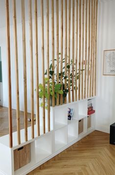 a room with wooden slats on the wall and bookshelves