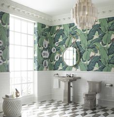 a bathroom with two sinks and a mirror in the middle of it, next to a toilet