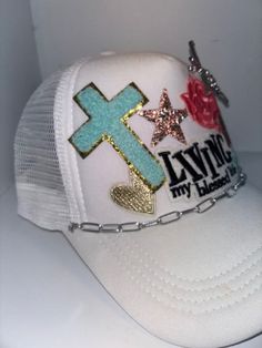 Faith themed Trucker Patch Hat. These are the hottest trend on social media today. Great for festivals, concerts, night life and everyday wear. This foam trucker hat is fully adjustable and offered in hat colors Black, White, Light Pink, Neon Pink, Neon Yellow and Green Camouflage. Custom Hats avail. One size fits all. $45 Small Print: patch, mama, cowboy, hat, faith, rock and Roll, trucker, patch, cap, chain, iron on, sew on, festival, concert, neon, baseball cap, ball hat, chain, vintage, retro, trendy, patch hat, cowgirl, rocker mama, mom, beanie, rodeo, applique designs, embroidered, polyester hat, gifts for her, night life, everyday hat, collage cap, sparkly, sparkle hat, horse, charms Trucker Hat Designs With Patches, Dance Diy, Hat Chain, Hat Bar, Women Trucker, Custom Truck, Patch Hat, Festival Concert, Hat Ideas