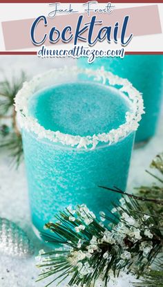 two glasses filled with blue cocktail next to pine branches