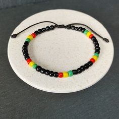 Rastafarian Seed Beads Bracelet, Adjustable Jamaican Bob Marley Style, Reggae Red, Yellow, Green, Black | Unisex Gift | Rastafari Vibes, One Love, Handmade Gift for Her and Him Rasta Bracelet - Radiate the Reggae Spirit! Handmade with a celebration of Rastafari Seed Beads in Jamaican Bob Marley Style. Capturing the Red, Yellow, Green, and Black essence of Reggae, this unisex bracelet is a unique gift for all. Handcrafted Details: Authentic Rastafarian Design: Representing unity, love and positiv Bob Marley Bracelet, Jamaican Bracelets, Rasta Bracelet, Beads Anklet, Style Bob, Reggae Style, Hippy Gifts, Handmade Gifts For Her, Unisex Gift