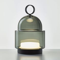 a table lamp that is on top of a stand with a circular light in the middle