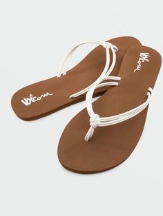 Truly softer with a thicker EVA footbed and added arch support for true comfort, you'll want to wear these cute white strap sandals forever and ever.  - 
 - Knotted Synthetic Leather Straps 
 - Soft EVA Footbed
 - Added Arch Support
 - Rubber Sponge Outsole White Synthetic Sandals For The Beach, White Synthetic Beach Flip Flops, White Synthetic Flip Flops For Beach, White Synthetic Sandals With Removable Insole, Trendy White Beach Slippers, Trendy White Vacation Slippers, White Textured Flip Flops For Vacation, White Textured Flip Flops For Beach, Casual White Sandals With Arch Support