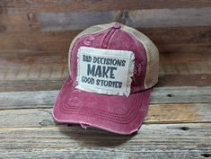 Bad Decisions Make Good Stories is a Funny Hat For Women. These Distressed Ponytail Hat are perfect for a vacation or Girls Trip Gift or a great Friend Gift. Tattered Ponytail Hat 20% Cotton 80% Polyester Double Fabric Brim 7 Panel Hat Patches have frayed edges and are printed with permanent ink. They are adhered to the hat with an iron and strong double sided interfacing. While I do my very best to photograph items to see their true color, due to the nature of electronic devices sometimes color Adjustable Distressed Pink Hat, Trendy Distressed Adjustable Hat, Trendy Adjustable Distressed Hat, Adjustable Distressed Baseball Cap, Distressed Adjustable Flat Brim Hat, Distressed Flat Brim Hat With Adjustable Fit, Pink Distressed Cap, Distressed Pink Hat One Size Fits Most, Distressed Pink Hat One Size