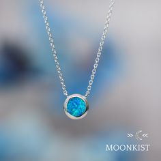 This minimalist necklace is wonderful for anyone with an October birthday! It works beautifully as a delicate layering necklace or an elegant solitaire pendant. Great for everyday wear, this man made blue opal pendant features a 8 mm round cabochon, hand set in a sterling silver bezel mountings. These mountings are firmly soldered and tumble polished for hours to increase durability. This necklace comes complete with a sterling silver chain measuring 16 inches in length, with an additional 2 inc Blue Sterling Silver Birthstone Necklace With Round Pendant, Blue Minimalist Sterling Silver Necklace, Minimalist Blue Sterling Silver Necklace, Minimalist Blue Necklace For Anniversary, Silk Bracelet, Opal Birthstone, Promise Rings For Couples, Solitaire Necklace, Buy Jewellery Online