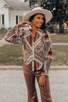 Stand out in our intricate 'Superb Views' top featuring lightweight chiffon material patterned with an abstract aztec print, a button down front with a collared neckline, long loose sleeves with flared cuffs, and a relaxed silhouette that falls into a rounded hemline! Measurements S : Bust 36", Hip 38", Length 23", Sleeve Length 23", Waist 37". M : Bust 38", Hip 40", Length 23.5", Sleeve Length 23.5", Waist 39". L : Bust 40", Hip 42", Length 24", Sleeve Length 24", Waist 41". Fall Abstract Print Button-up Blouse, Patterned Long Sleeve Boho Print Blouse, Patterned Long Sleeve Blouse For Festivals, Trendy Long Sleeve Blouse With Geometric Pattern, Bohemian Collared Tops For Fall, Bohemian Printed Blouse For Fall, Fall Bohemian Collared Tops, Brown Long Sleeve Festival Top, Brown Long Sleeve Top For Festival