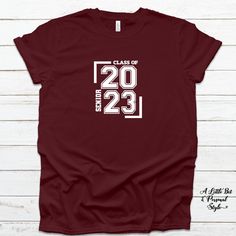 Senior 2023! Screen printed design on a soft bella tee! Shown on a maroon color tee. Graphic Tee T-shirt For College Events, Graphic Tee With Text Print For College Events, Short Sleeve T-shirt With Text Print For College Events, Custom Print Cotton T-shirt For College Events, Text Print Short Sleeve T-shirt For College Events, Casual Custom Print T-shirt For College Events, Casual T-shirt With Custom Print For College Events, Custom Print Crew Neck T-shirt For College Events, Senior 2023