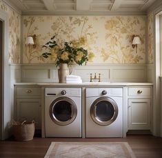 a washer and dryer in a room with floral wallpaper on the walls