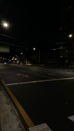 an empty street at night with no traffic