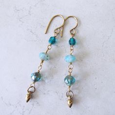 "Czech Blue Beachy Glass Linear Earrings on Brass 3\" Long." Blue Drop Earrings For Summer, Summer Blue Drop Earrings, Blue Earrings For Vacation, Blue Ear Wire Earrings For The Beach, Blue Beaded Ear Wire Earrings For Summer, Blue Beaded Earrings With Ear Wire For Summer, Nickel Free Blue Earrings For Summer, Nickel-free Blue Earrings For Summer, Summer Blue Nickel-free Earrings