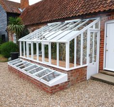 a green house sitting next to a brick building with the words, considerations before building lean to greenhouse