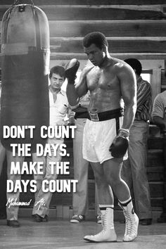 a man standing next to a punching bag with a quote on it that reads, don't count the days make the days count