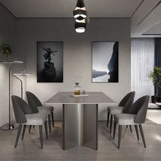 a dining room table with four chairs around it and two pictures on the wall behind it