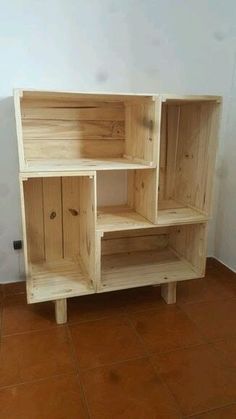 a wooden shelf sitting on top of a tiled floor