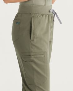 Experience the perfect fusion of fashion and function with our Tanna Cargo Pants, designed to meet the unique needs of the modern healthcare professional. Crafted with meticulous attention to detail, these cargo pants feature a tapered leg style and slim fit, offering a contemporary and flattering silhouette that enhances your workday wardrobe. - Slim fit - Inseam 29 1/2" - Total of seven pockets ✓ Two front pockets ✓ One side pocket with a signature tape on the left side ✓ One side pocket with Functional Cargo Pants With Cargo Pockets For Work, Straight Leg Joggers With Pockets For Workwear, Functional Bottoms With Cargo Pockets And Tapered Leg, Functional Bottoms With Tapered Leg And Cargo Pockets, Functional Tapered Leg Bottoms With Cargo Pockets, Workwear Cargo Pants With Functional Pockets And Tapered Leg, Tapered Leg Cargo Pants With Functional Pockets For Workwear, Functional Cargo Work Pants, Tapered Leg Workwear Joggers With Pockets