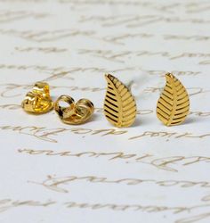 These exquisite, 22k gold plated, brass stud gold earrings are shaped as delicate leaves to stimulate in the wearer an awareness and a closeness with nature. The gold earrings are part of a special fall collection and are 1cm. in size. Hand Made In a Smoking-Free Studio More Gold Leaf Jewelry http://www.etsy.com/shop/gazellejewelry/search?search_query=gold+leaf Wedding Jewelry http://www.etsy.com/shop/gazellejewelry/search?search_query=wedding Shipping Info: I accept PayPal and credit card! I sh Gold Leaf Jewelry, Earrings Nature, Feather Bracelet, Studs Gold, Nature Earrings, Gold Leaf Earrings, Stud Earrings Gold, Leaf Jewelry, Tiny Stud Earrings