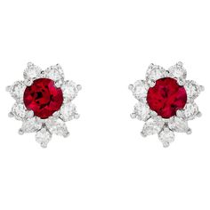 Illuminate your style with the captivating brilliance of Tiffany & Co.'s bright red ruby earrings. Set in platinum, these exquisite gems are embraced by a sparkling diamond halo, evoking a timeless elegance that exudes sheer sophistication. The two red rubies are round shape, and weigh approximately 1.20 total carats. There are 4 marquise and 14 round diamonds that surround the rubies; they weigh approximately 1.00 total carat and are E-F color with VS clarity. They are stamped "© Tiffany & Co. PT950" Luxury Ruby Diamond Earrings For Anniversary, Tiffany And Co Earrings Bloomingdale's, Red Diamond Earrings, Tiffany And Co Earrings, Red Ruby Earrings, Ruby Earrings Studs, Tiffany Jewelry, Halo Earrings Studs, Red Diamond