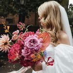 a bride holding a bouquet of flowers in her hand