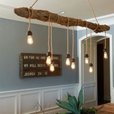 the light bulbs are hanging from the wood beam in the dining room area, which is decorated with driftwood planks