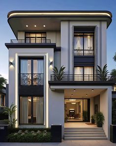 a large white house with lots of windows and balconies on the second floor