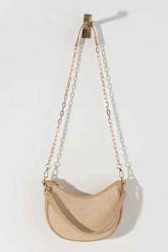 Adrienne Shoulder Bag in Natural Take your summer wardrobe to the next level with the luxurious Adrienne Shoulder Bag in Natural. This trendy bag, crafted from high-quality raffia fabric, is a versatile accessory that can accompany you on any occasion. The detachable single handle and cross-body chain strap allow for endless styling possibilities, making it a must-have for the season. Versatile Beige Straw Shoulder Bag, Spring Beige Shoulder Baguette Bag, Beige Shoulder Baguette Bag For Spring, Beige Baguette Shoulder Bag For Spring, Versatile Beige Satchel Straw Bag, Chic Beige Straw Bag For Travel, Versatile Beige Straw Bag With Double Handle, Everyday Straw Shoulder Bag With Detachable Handle, Trendy Beige Jute Shoulder Bag