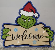 the grin face is holding a welcome sign