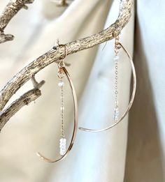 "This pair of dramatic earrings swing gracefully from the ear. They are bronze arcs in a crescent moon shape accented by a length of chain ending in gemstones(the stars!). The effect is ethereal. Available in rainbow moonstone or pyrite gems. Ear wires are 14k gold filled or sterling. Length is approx. 3.25\"." Star Wire Earrings, Elegant Half Moon Metal Earrings, Elegant Crescent Moonstone Jewelry, Elegant Semi-circle Metal Jewelry, Elegant Brass Earrings With Moon Charm, Elegant Moon Shaped Metal Earrings, Elegant Moon-shaped Metal Earrings, Elegant Half Moon Earrings With Moon Charm, Elegant Crescent Moon Charm Earrings