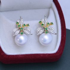 Our 11-12mm Freshwater Pearl & Color Floral Earrings are the perfect way to show off your unique style. The glimmering pearls and vibrant flower design will instantly add charm to any look. Exuding elegance, these earrings are perfect for any occasion, formal or casual. Crafted by House of Pearls, these earrings are sure to become your favorite go-to accessory. Make a timeless statement with every wear and step out with confidence! Pearl size:Earrings: 11-12mm This popular earrings design featur Elegant Green Flower Earrings For Formal Occasions, Elegant Green Round Flower Earrings, Elegant Green Flower Earrings, Elegant Sterling Silver Pearl Earrings In Flower Shape, Elegant Flower-shaped Sterling Silver Pearl Earrings, Formal Flower-shaped Pearl Earrings For Pierced Ears, Elegant White Round Flower Earrings, Elegant White Floral Earrings, Flower Shaped Pearl Earrings For Anniversary