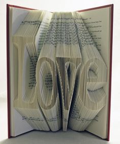 an open book with the words love written on it, in spanish and english language