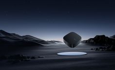 an object floating in the middle of a desert at night with mountains and stars behind it