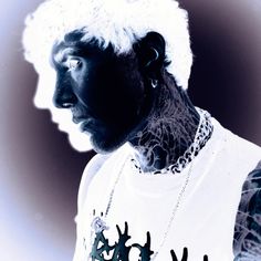 a man with white hair and tattoos on his face