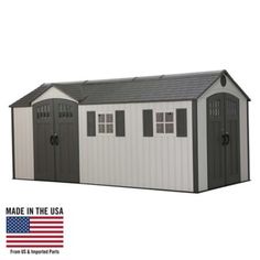 a white and gray shed with an american flag in the backgroung, made in the usa